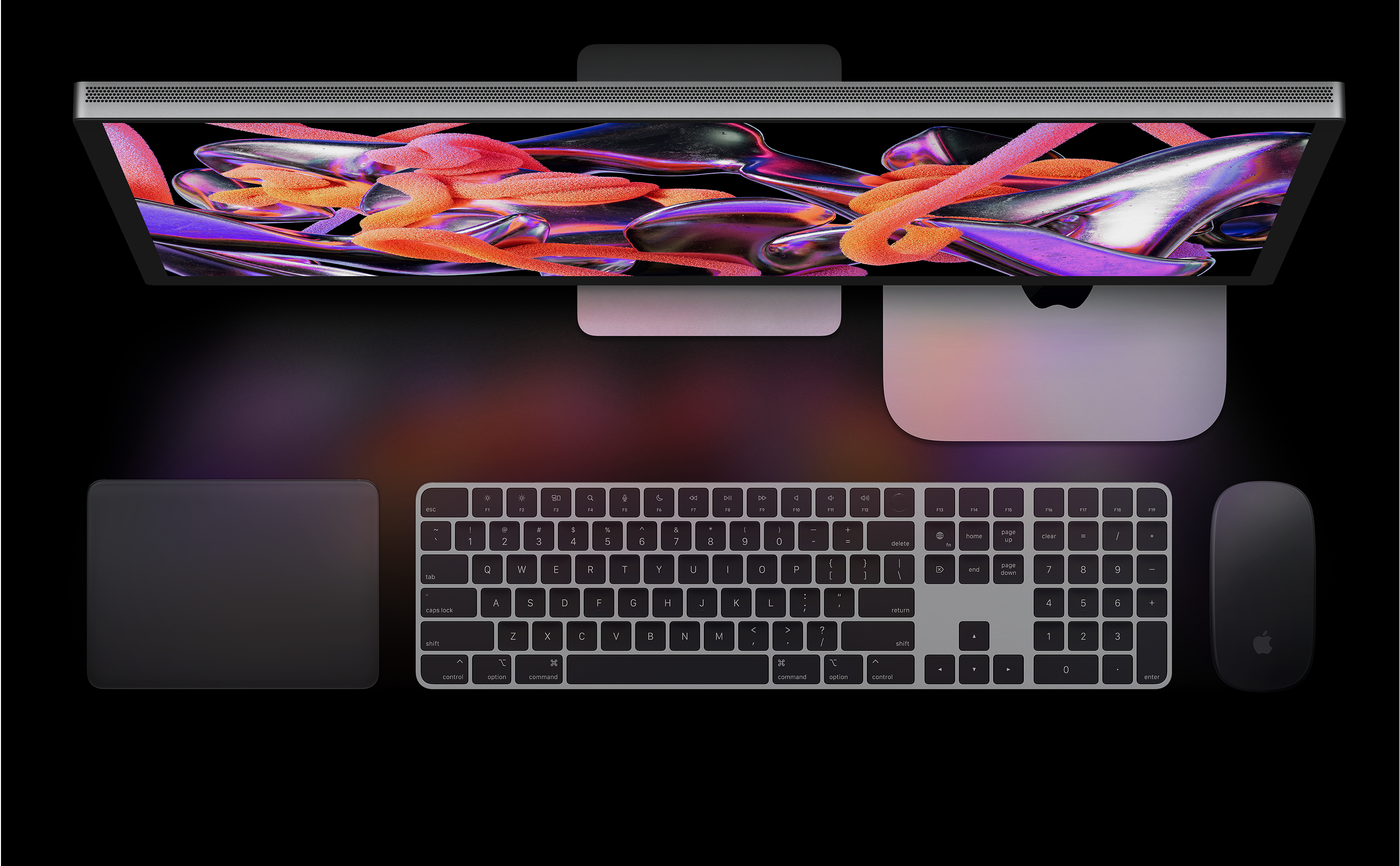 Studio Display, Mac mini, Magic Trackpad, Magic Keyboard et Magic Mouse vus d'en haut.